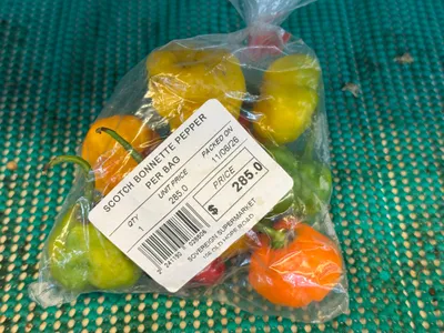 Whole, hot Jamaican scotch bonnet peppers packaged in a plastic bag. These are great for cooking zesty dishes.
