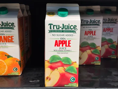 Apple juice with added vitamin C in a carton.
