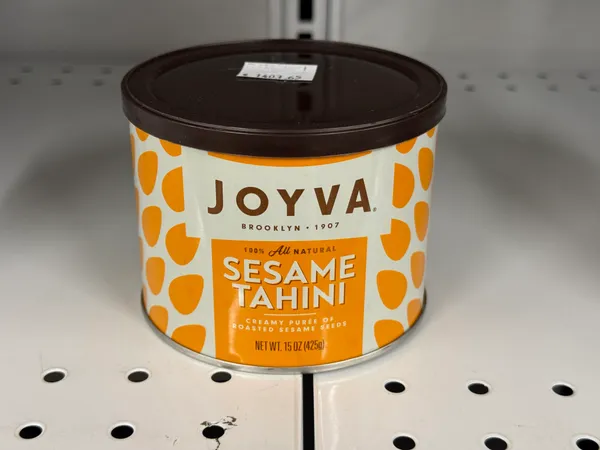 Creamy puree of roasted sesame seeds in a tin.